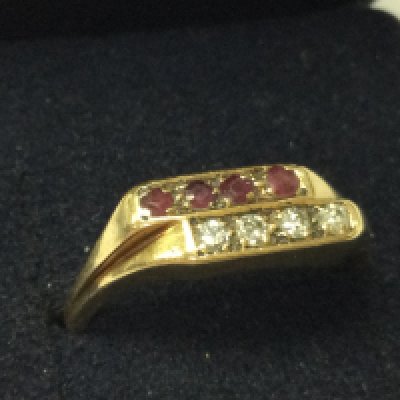 A 9ct gold diamond and ruby ring , size O. 2.9g total weight. Postage category A