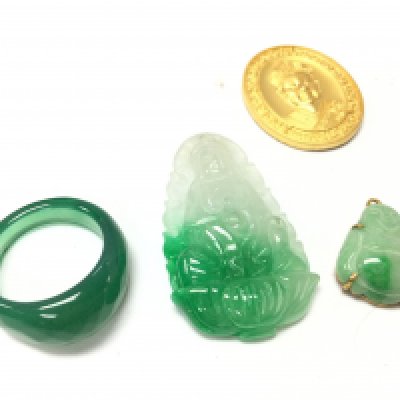 A collection of jade including a ring and pendants . Postage category A
