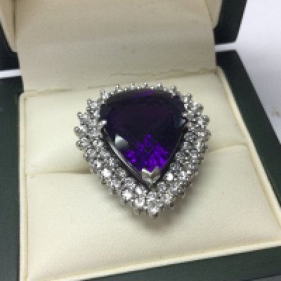 An 18ct white gold pear shaped amethyst ladies ring , 13.75ct deep purple 22 stones diamond total approx 1.6ct . Size L/M . 14g total weight. Postage category A