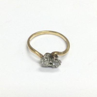 An 18ct gold two stone diamond crossover ring, approx size N-O and approx 1.9g. Shipping category A.
