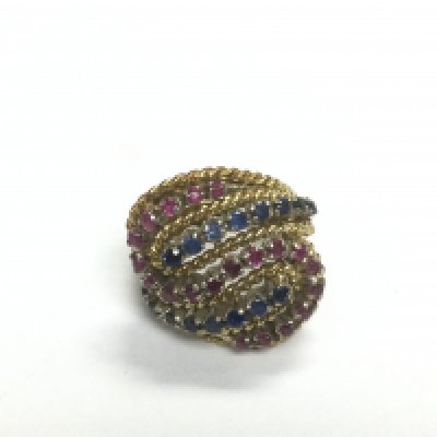 An 18ct gold ring set with rubies and sapphires, approx size E-F and approx 8.7g. Shipping category A.