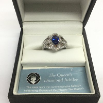 A 14ct white gold ring set with a central blue sapphire and small diamonds, approx size O and approx 5.7g. Shipping category A.