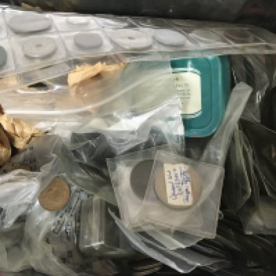 Two tins containing a collection of used circulated world coinage including George III and other pre 1946 silver coinage and a collection of United Kingdom uncirculated coinage.