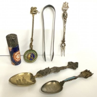 A small collection of silver spoons and items of virtue. (B)