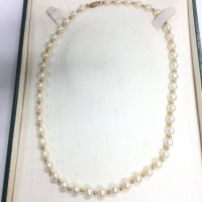 A pearl necklace interspersed with gold beads. Shipping category A.
