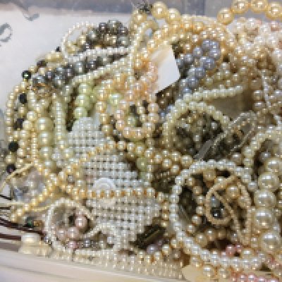 A box of mixed simulated pearl jewellery including necklaces, bracelets etc . Postage category B