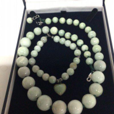 A Chinese jade necklace graduating jade beads and a matching bracelet with heart shaped link.