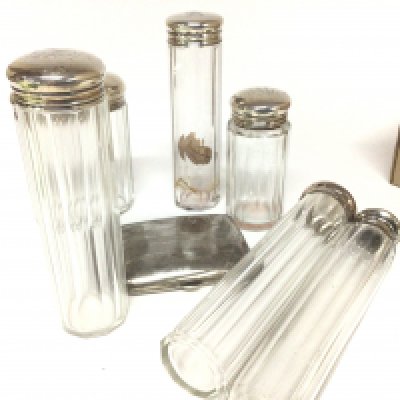 A silver cigarette case and silver topped tidy jars maker walker Hall London with personal initial inscriptions.