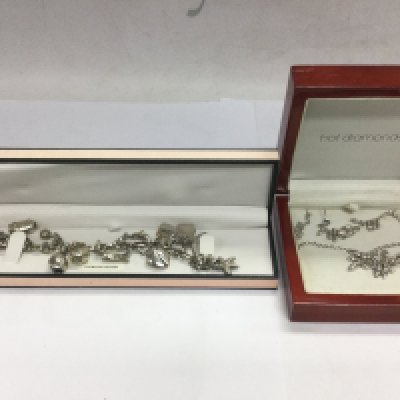 A hot diamonds silver charm bracelet with 13 or diamond charms together with a hot diamonds silver necklace and earring set (2). Shipping category A.