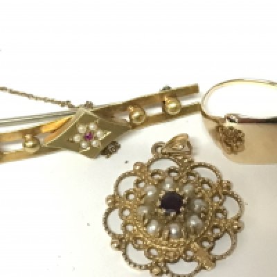 A gold ring and two brooches one with a steel pin all unmarked yellow metal. Total weight 11g.