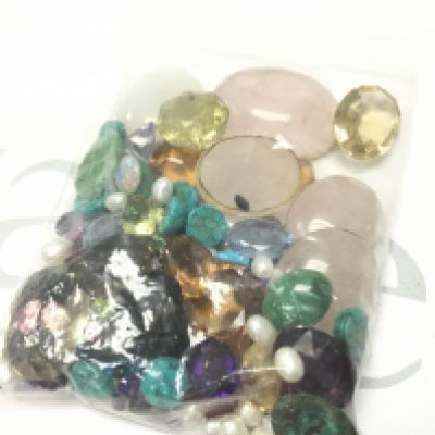 A bag of mixed gemstones , postage category A