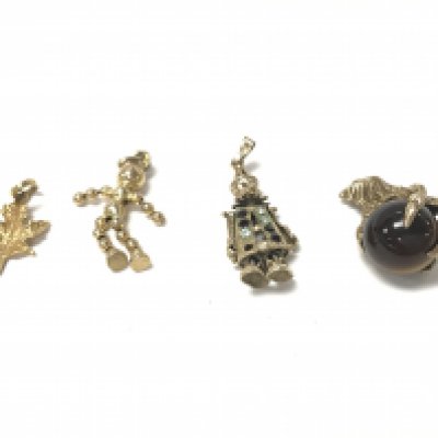 A collection of four gold charms. Total weight 10.55g.