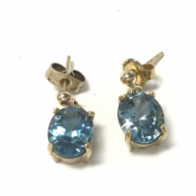 A pair of 9ct gold earrings set with pale blue stones. 4.16g Postage A