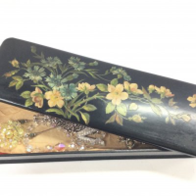 A Victorian papermache box with costume jewellery including necklaces and brooches. Postage category B