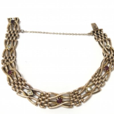 A 15ct gold bracelet set with diamonds and Ruby's. 17.96g