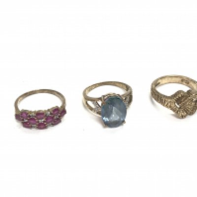Three 9ct gold rings including a Ruby one size P a topaz size P and one other size O.11.69g