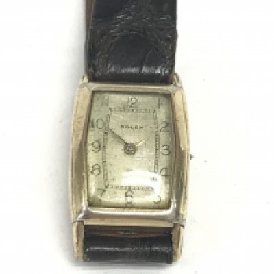 A 10ct gold filled vintage Rolex watch on brown leather strap. In need of repair. Postage B