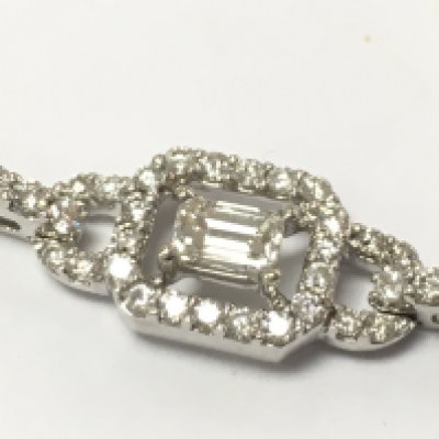 An 18ct white gold line bracelet set with nice sections of emerald cut diamonds linked with brilliant cut diamonds. 5.38carat total weight. Colour G. 20cm long.Postage B