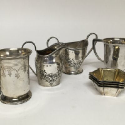 A silver cream jug with matching sugar bowl a Sterling silver Art Deco design jug a white metal small tankard and a set of four salt cellars