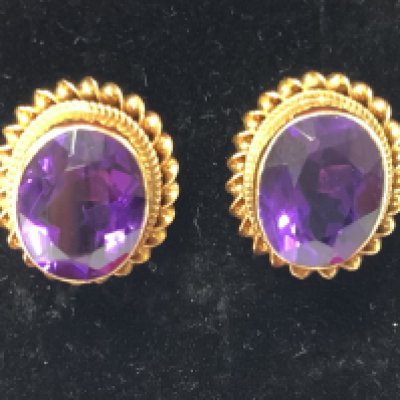 A pair of 9ct amethyst studs. Postage category A.