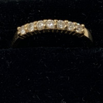 A 14ct gold half maternity ring set with CZ stones. Approximately L/M. Postage category A.