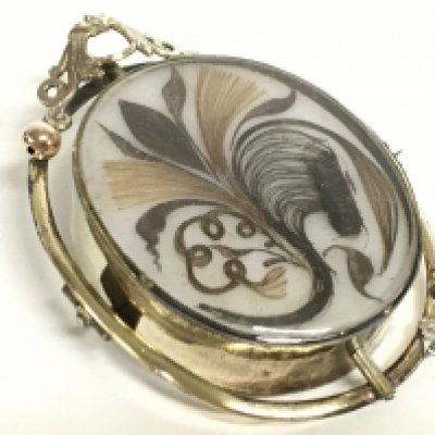 A Victorian swivel mourning brooch with hair design. This lot cannot be posted