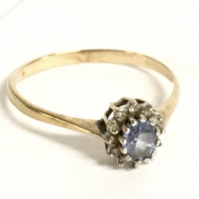 A 9 carat gold ring set with an aquamarine stone and diamond shards. Size R. 1.6g Postage category a
