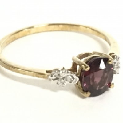 A 9 carat gold ring set with a garnet stone and small diamonds, size U, 1.9g. Postage category a