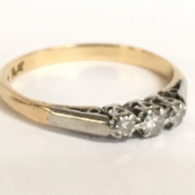 An 18 carat three stone platinum and diamond set ring. Size Q. 2.5g Postage category A