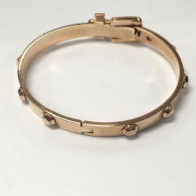 A Michael Kors metal bracelet with pouch and box. Postage B