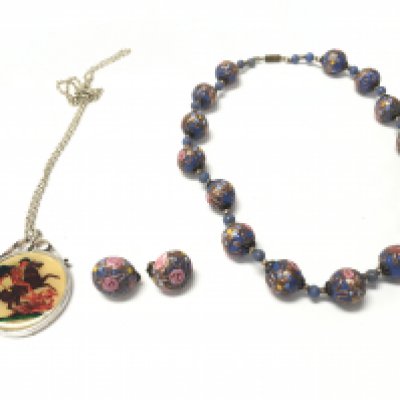 A glass necklace and silver coin pendant. Postage B