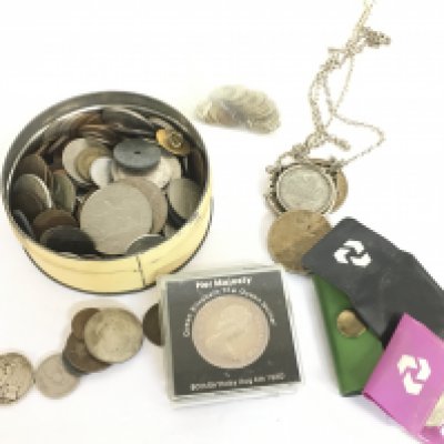 A collection of coins including 1922 one dollar, 1943 half crown, 1921 one dollar, 1887 silver sovereign