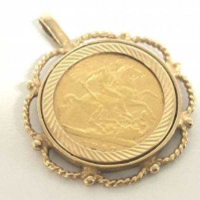 A 9ct gold mounted 1897 Half Sovereign. Total weight 6.8g. Postage category A