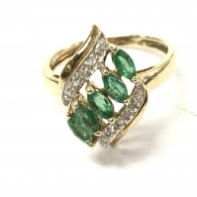 A 9ct gold diamond and emerald ring. Size O and 2.58g.