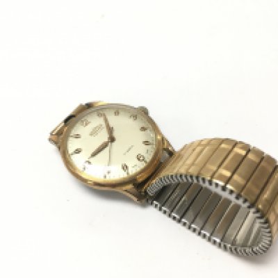 A gents yellow coloured roamer watch