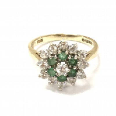 A 9ct gold emerald and diamond cluster ring. Size M 1/2 and 3.02g