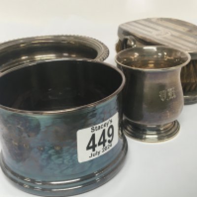 A silver wine coaster 958 Britannia silver marks a pair of silver brushes and a small silver tankard and other silver plated oddments.
