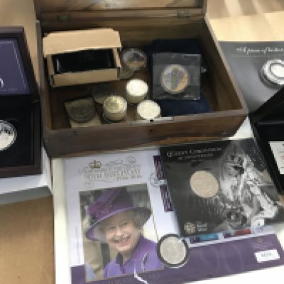 A box containing a collection of coinage including silver commemorative