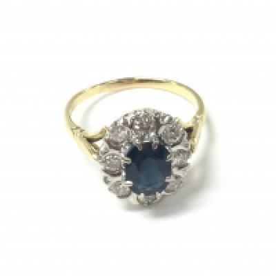 18ct yellow and white gold vintage style oval sapphire and RBC diamond cluster ring. Sapphire 1ct and diamonds 0.65ct approximately. Size S and 5.3G. Postage A