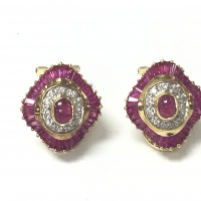 A pair of 18ct yellow gold ballerina style stud earrings set with central cabochon rubies surrounded by RBC diamonds and rapered baguette and calibre cut rubies. Rubies 2ct and diamonds 0.40ct approximately. Postage A