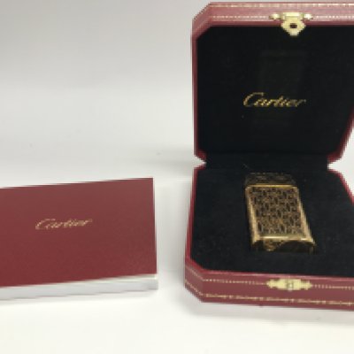 A boxed Cartier pink and gold lighter With bag and booklet. Seen working.