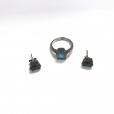 A silver ring and earrings set with blue stones.