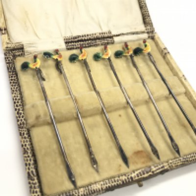 A boxed set of silver and enamelled cockerel cocktail sticks. Postage category A