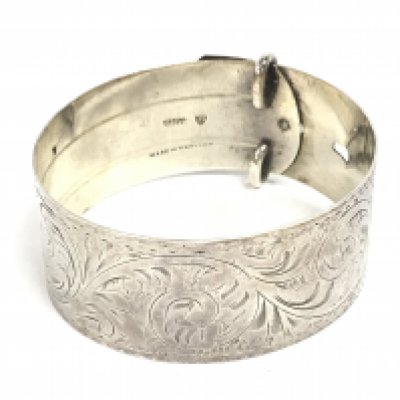 A sterling silver buckle bangle. Postage category A