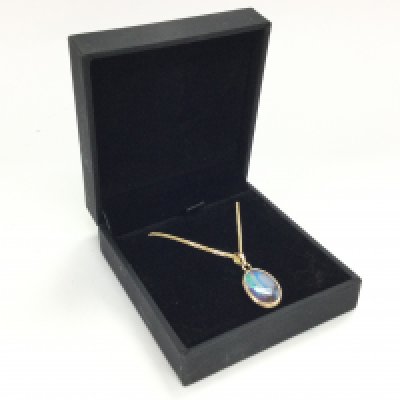 A gold opal pendant on chain, postage category A