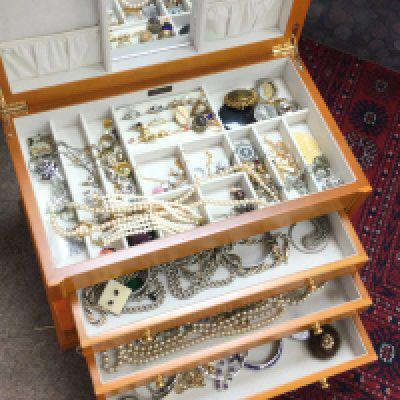 A box of costume jewellery including necklaces, brooches, bracelets etc. postage category C