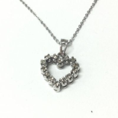 An 18ct white gold diamond set heart pendant on a silver chain. Postage A