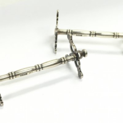 A pair of silver hallmarked knife rests, postage category A