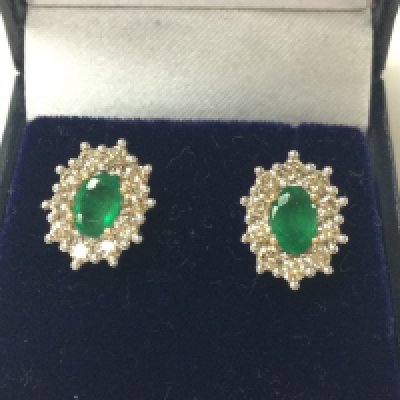 A pair of 9ct yellow and white gold oval emerald and RBC diamond cluster studs. Emerald 1.01ct and diamonds 1ct approximately. Postage A
