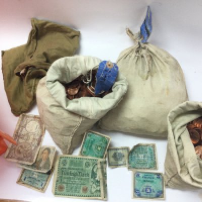 A large collection of assorted coinage and bank notes including a a sealed bag on 1/2 pence coins and an opened bag. No postage due to weight.